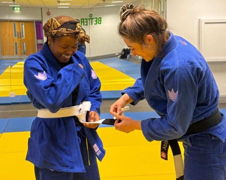Coach Abbie awarding BJJ belt promotion